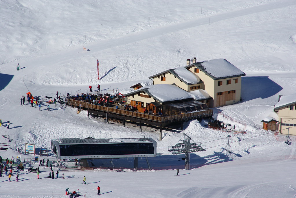 Aerial photograph of Chalet Chinal Donat restaurant and its large sunny terrace at Plan Bouchet in Orelle, located above the Col de Rosaël chairlift and Orelle gondola arrival.